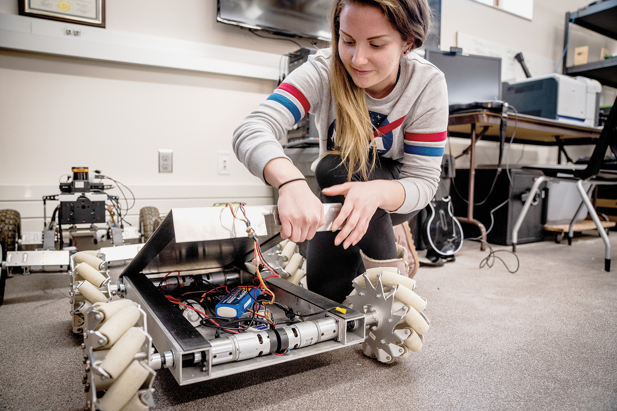 South Dakota Mines Student showcasing her robotics project